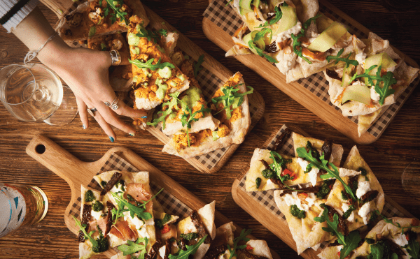 Woman picking up piece of flatbread